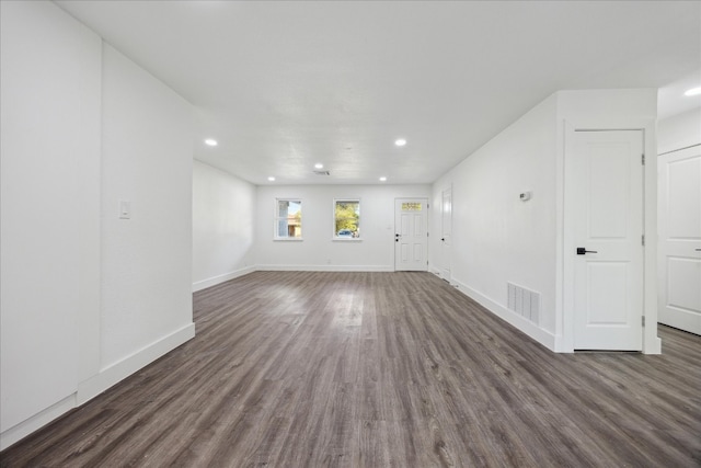 unfurnished living room with dark hardwood / wood-style flooring