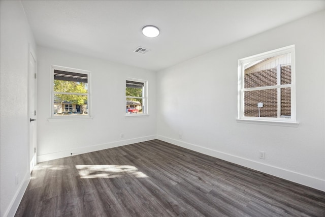 spare room with dark hardwood / wood-style flooring