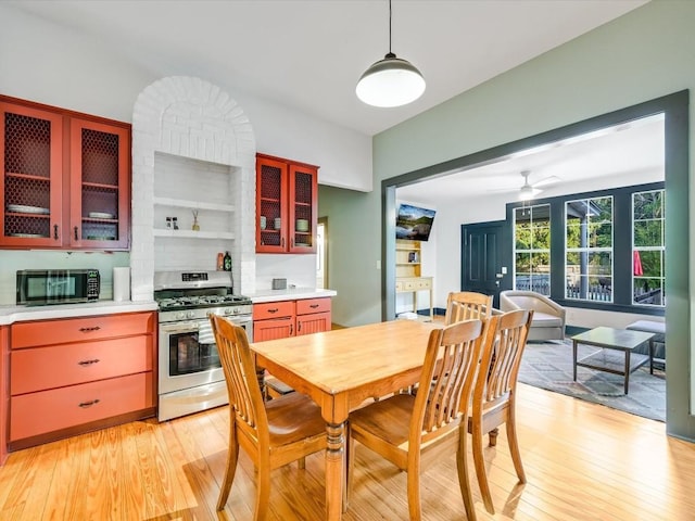 dining space featuring light wood-style floors and a ceiling fan