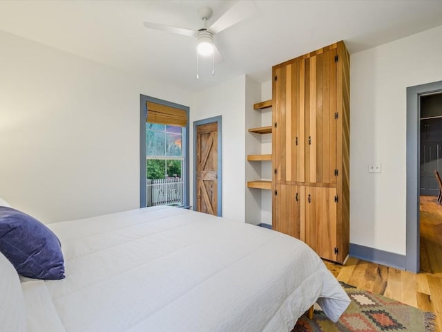 bedroom with a ceiling fan, baseboards, and light wood finished floors
