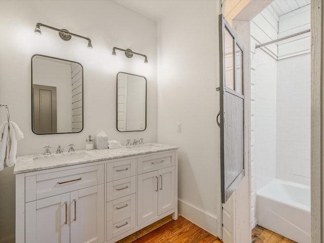 bathroom with  shower combination, vanity, and hardwood / wood-style flooring