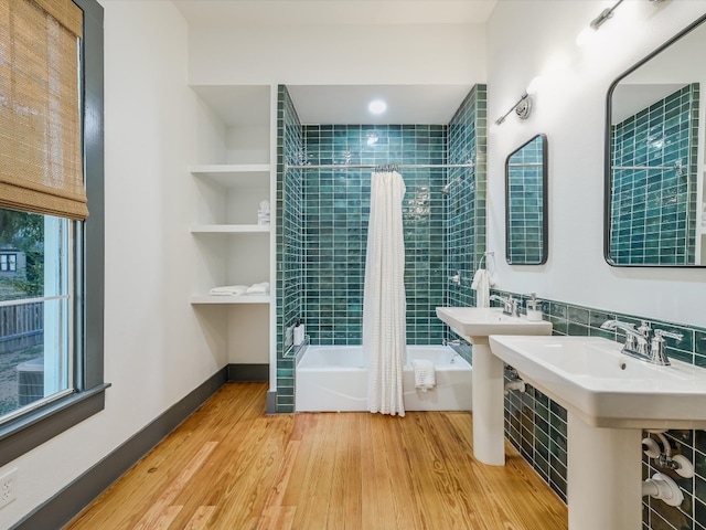 bathroom with shower / tub combo with curtain and wood-type flooring