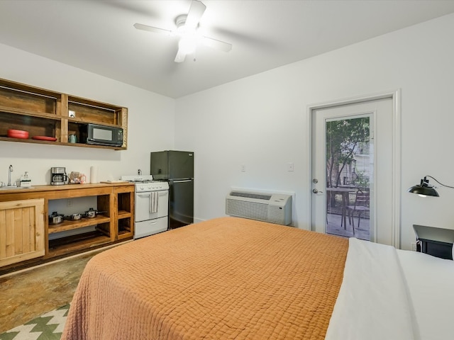 bedroom featuring ceiling fan, black fridge, access to outside, an AC wall unit, and sink