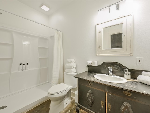 bathroom with vanity, toilet, and walk in shower