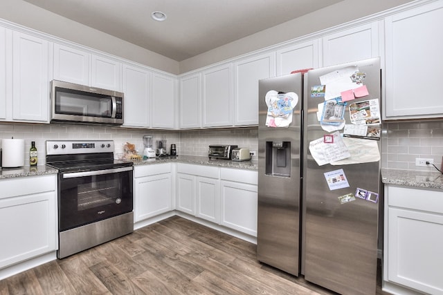 kitchen with white cabinetry and stainless steel appliances