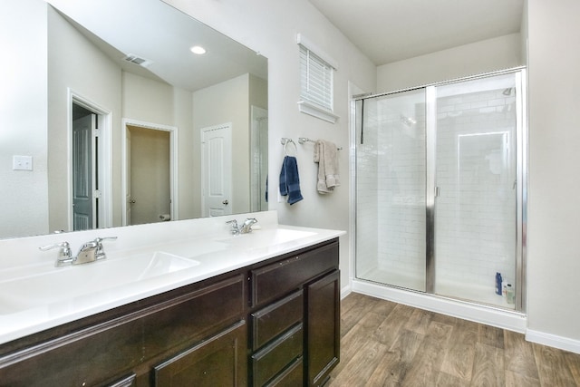 bathroom featuring hardwood / wood-style flooring, vanity, toilet, and an enclosed shower