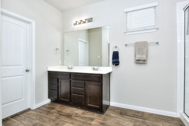 bathroom featuring hardwood / wood-style floors, vanity, and walk in shower