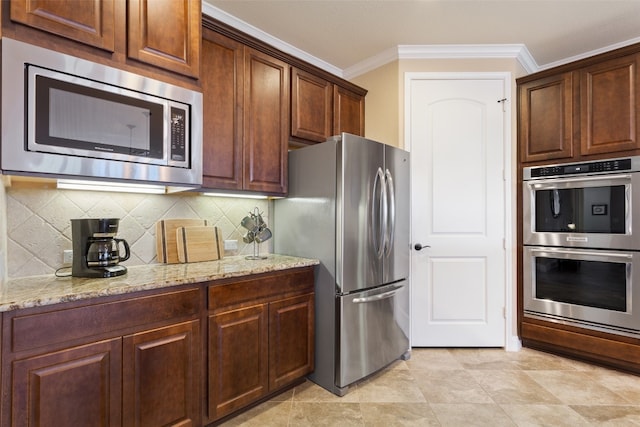 kitchen featuring ornamental molding, light stone countertops, stainless steel appliances, and tasteful backsplash