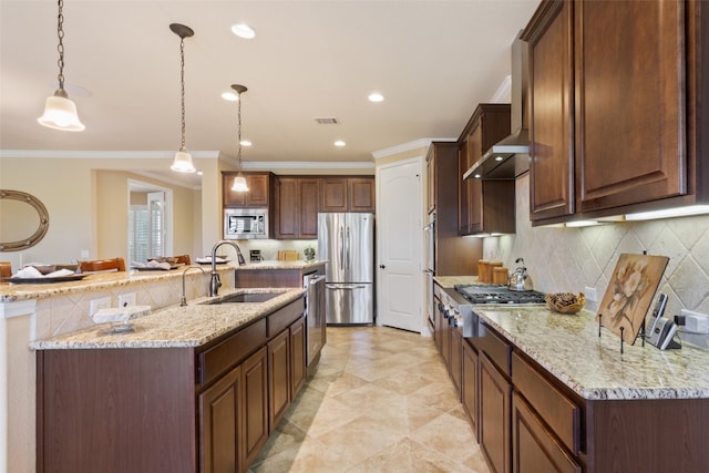 kitchen featuring stainless steel appliances, sink, light stone counters, and pendant lighting