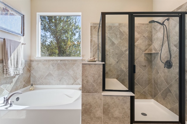 bathroom with separate shower and tub