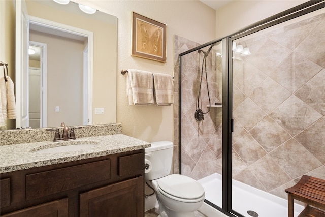 bathroom with vanity, toilet, and an enclosed shower