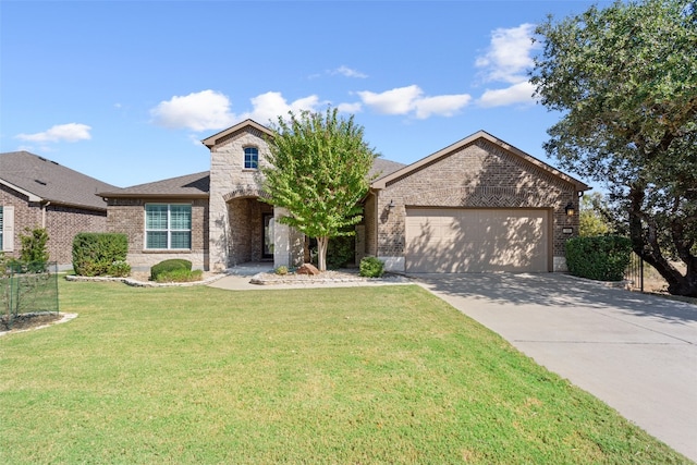 view of front of property featuring a front yard and a garage