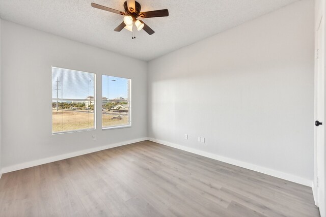 unfurnished room featuring a textured ceiling, wood-type flooring, and ceiling fan