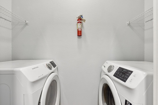 clothes washing area with washing machine and clothes dryer