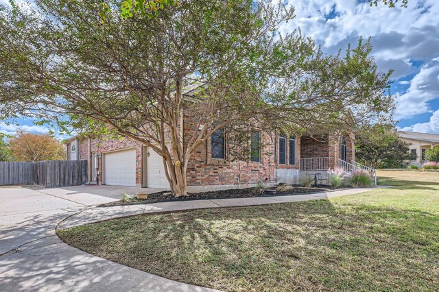 view of front of house featuring a front lawn and a garage