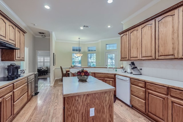 kitchen featuring decorative backsplash, hanging light fixtures, light hardwood / wood-style flooring, dishwasher, and crown molding