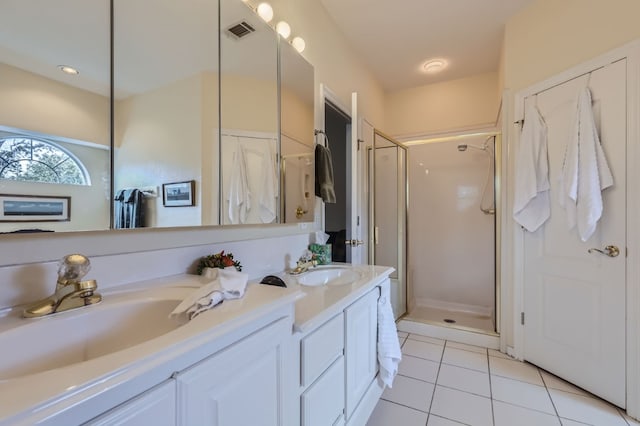 bathroom featuring vanity, tile patterned floors, and walk in shower