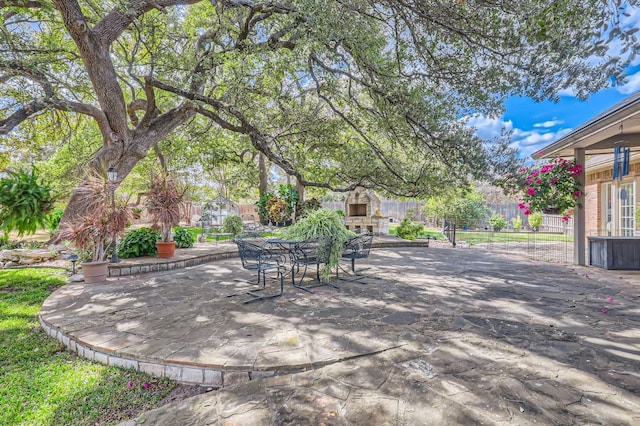 view of patio / terrace with an outdoor stone fireplace