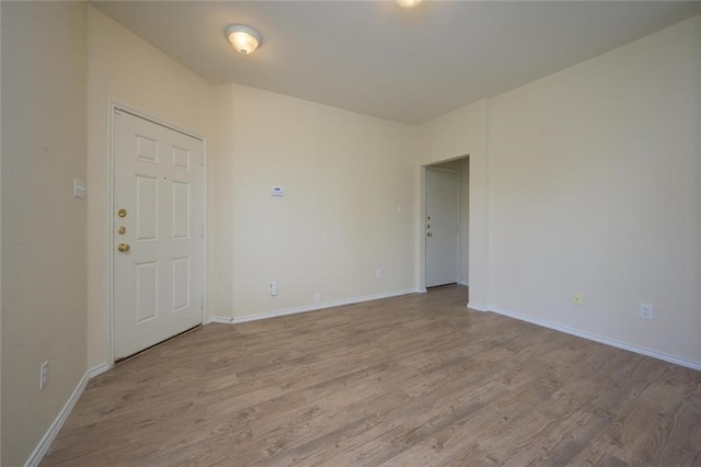 unfurnished room with light hardwood / wood-style flooring