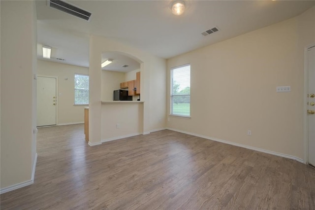 unfurnished living room with light hardwood / wood-style flooring