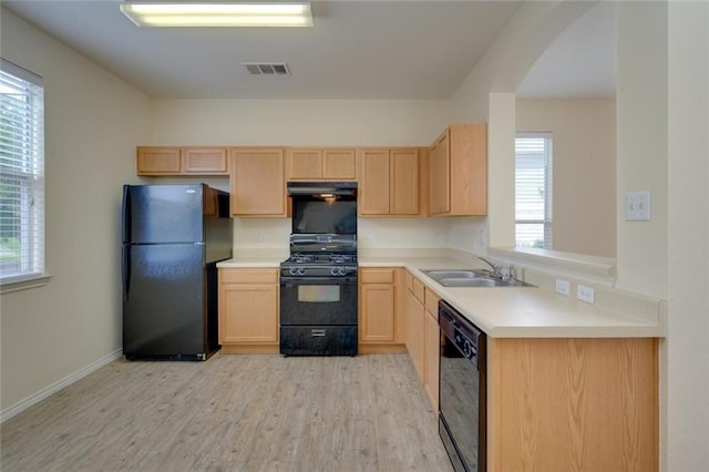 kitchen featuring light hardwood / wood-style floors, black appliances, light brown cabinetry, and sink