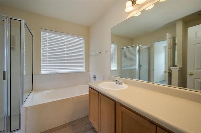 bathroom with vanity, shower with separate bathtub, and hardwood / wood-style flooring