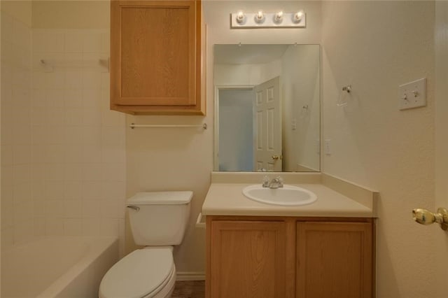 full bathroom featuring vanity, tiled shower / bath combo, and toilet