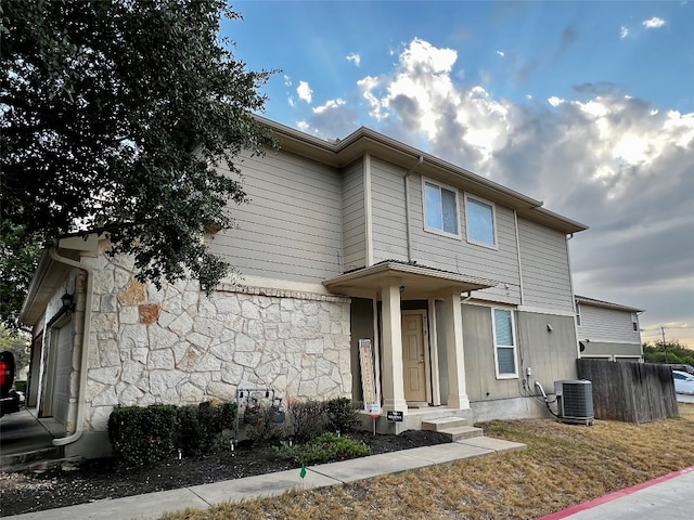 view of front of home with a garage and central AC unit