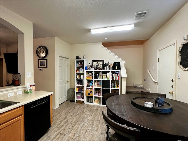 interior space with light hardwood / wood-style floors and a textured ceiling