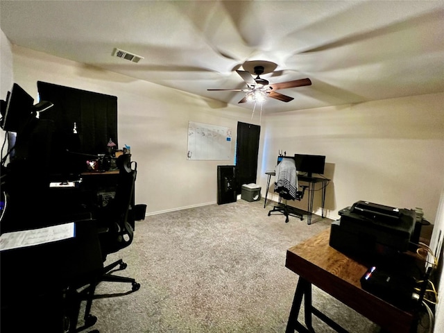 carpeted office space with ceiling fan