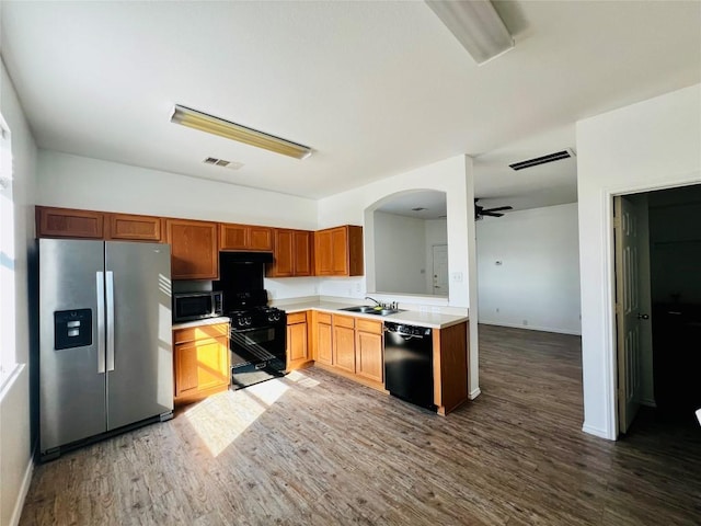 801 Jane Austen Trl Unit B, Pflugerville, TX 78660 - kitchen with black appliances, ceiling fan, light countertops, and wood finished floors