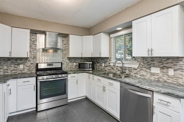 4308 Molokai Dr, Austin, TX 78749 - kitchen with appliances with stainless steel finishes, wall chimney exhaust hood, a sink, white cabinets, and a textured ceiling