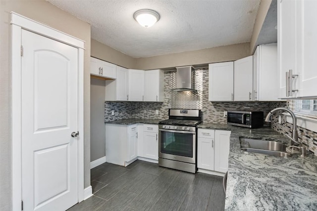 4308 Molokai Dr, Austin, TX 78749 - kitchen with stainless steel appliances, wall chimney exhaust hood, a sink, decorative backsplash, and dark stone counters