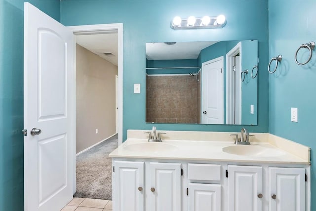 bathroom with tile patterned floors, double vanity, visible vents, and a sink