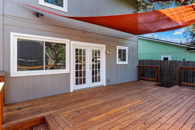wooden terrace featuring french doors and fence
