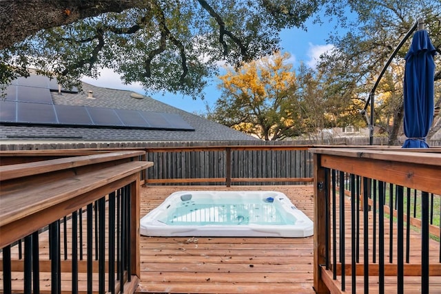 wooden deck featuring fence and hot tub deck surround