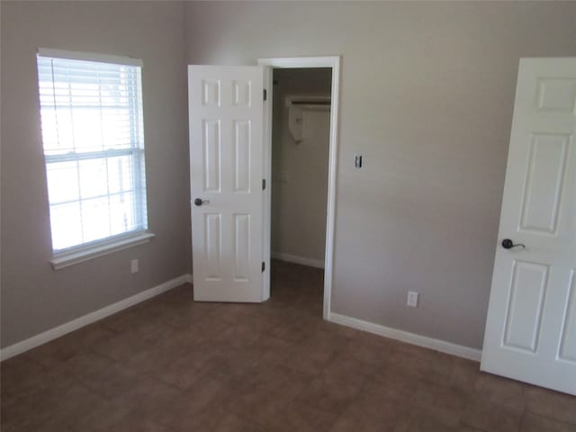 unfurnished bedroom featuring a closet and a walk in closet