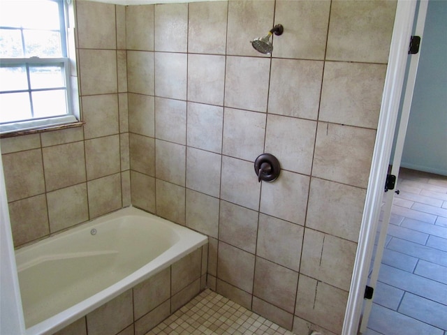 bathroom with tiled shower / bath and tile patterned floors