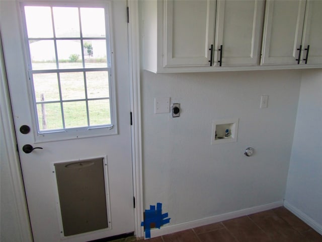 clothes washing area with hookup for a washing machine, electric dryer hookup, cabinets, and a wealth of natural light