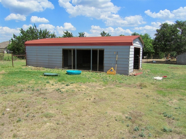 view of outbuilding with a lawn