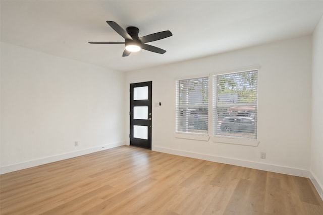 spare room featuring light wood-type flooring and ceiling fan