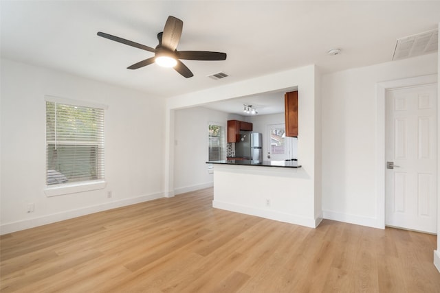 unfurnished living room with light hardwood / wood-style flooring and ceiling fan