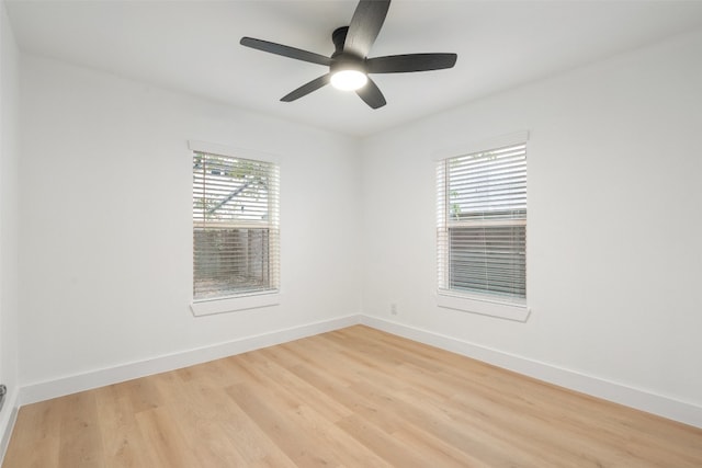 spare room featuring ceiling fan, light hardwood / wood-style floors, and plenty of natural light