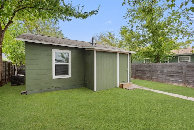 exterior space with a yard and central air condition unit