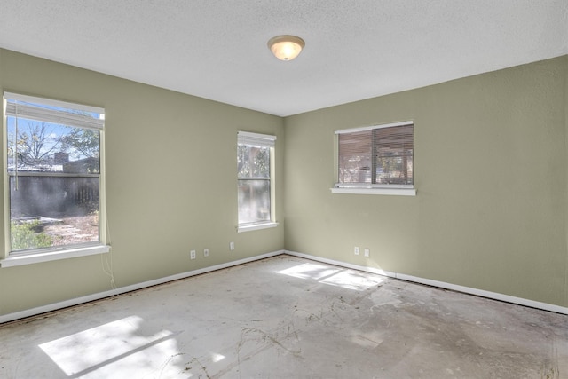 unfurnished room featuring a textured ceiling