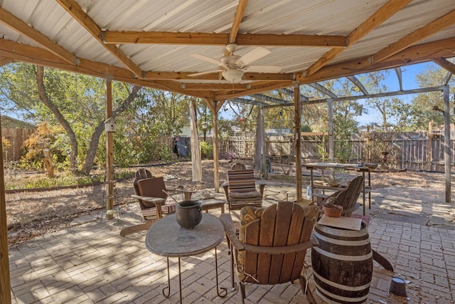 unfurnished sunroom with ceiling fan and vaulted ceiling with beams