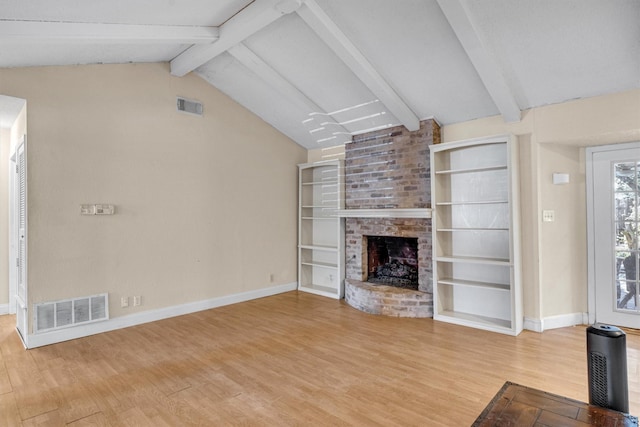 unfurnished living room with built in shelves, wood-type flooring, vaulted ceiling with beams, and a fireplace