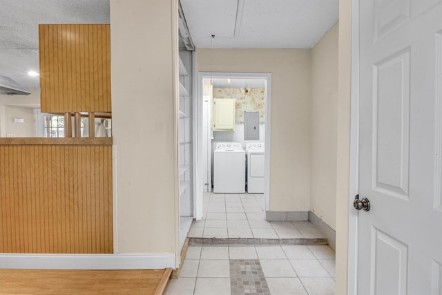 hall featuring electric panel, light tile patterned floors, a textured ceiling, and independent washer and dryer