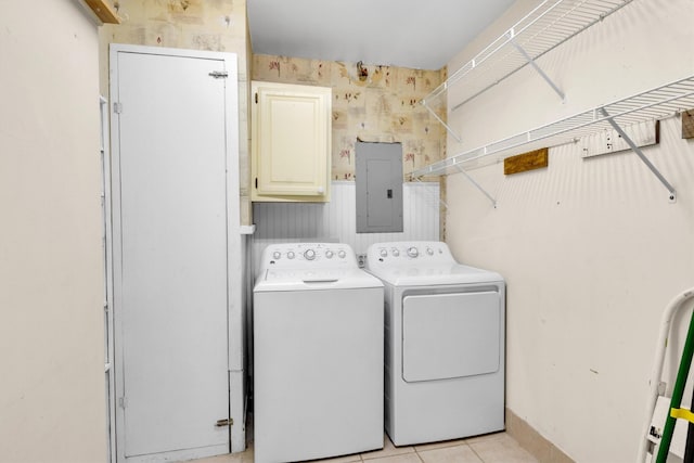 washroom featuring washer and clothes dryer, cabinets, electric panel, and light tile patterned flooring