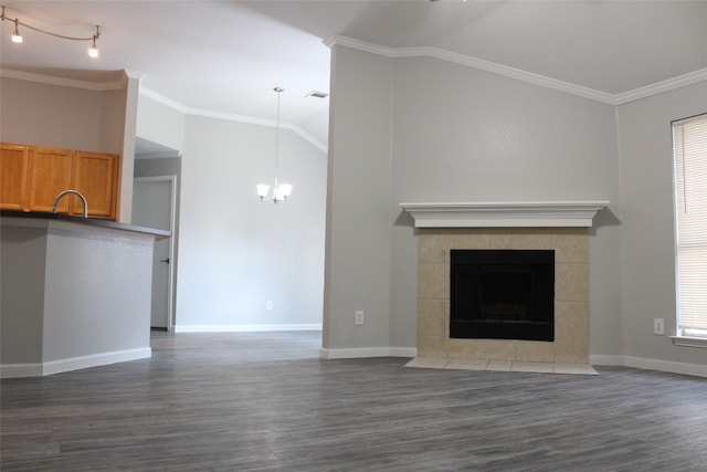 unfurnished living room with ornamental molding, dark wood-type flooring, and vaulted ceiling